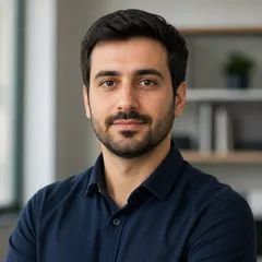 Professional author portrait featuring a neutral adult with natural hairstyle, smart casual attire, and a softly blurred back